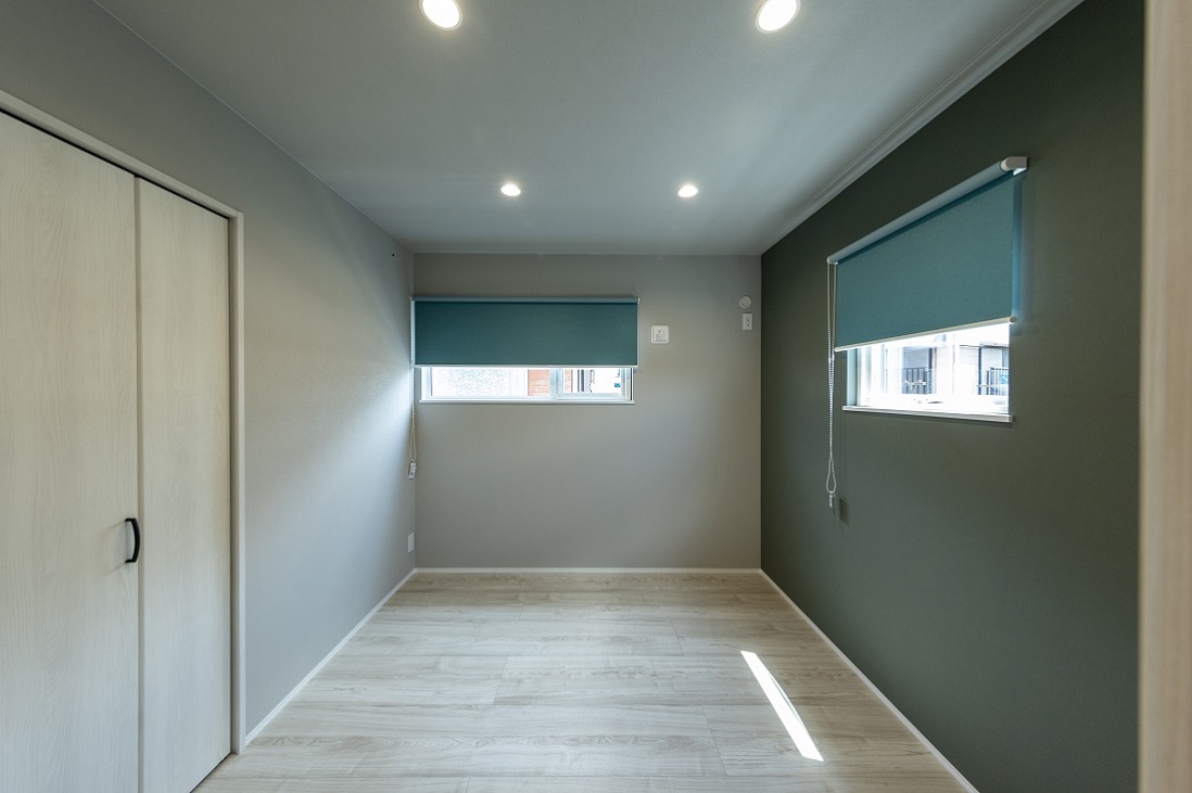 フォレストグリーンがアクセントの落ち着いたベッドルーム