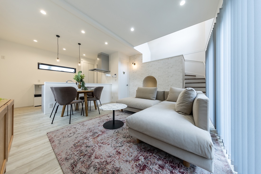 【吹抜けるスキップフロアから柔かい陽が届く家】