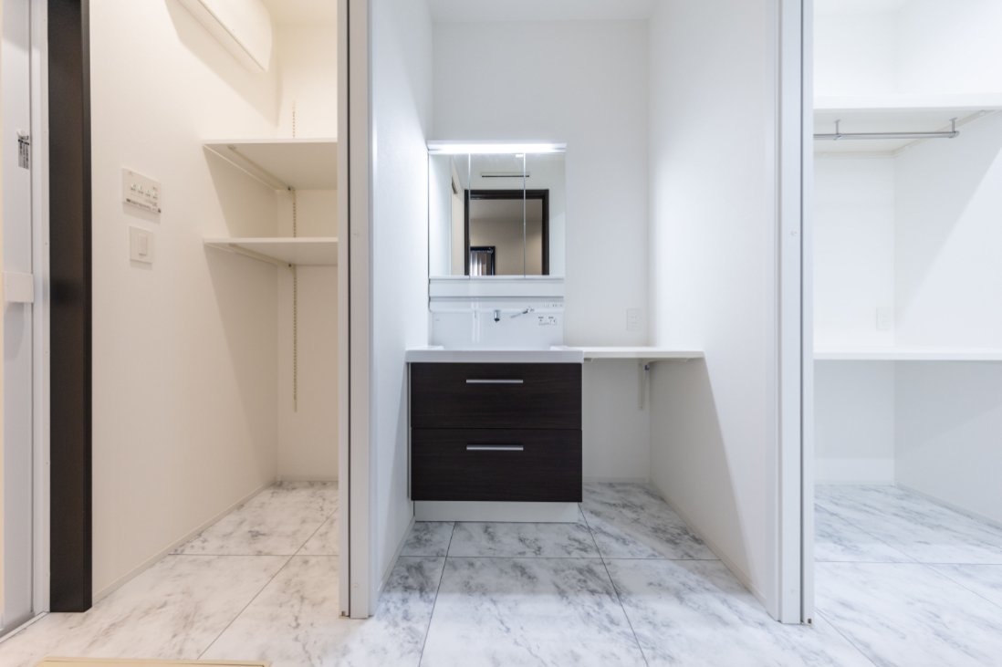 清潔感のある白でコーディネートした横並びの洗面・脱衣・ランドリールーム